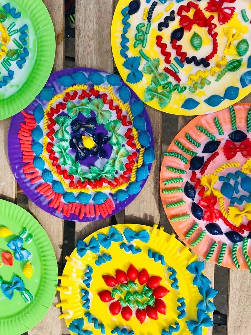 Paper plate mandalas made from coloured pasta