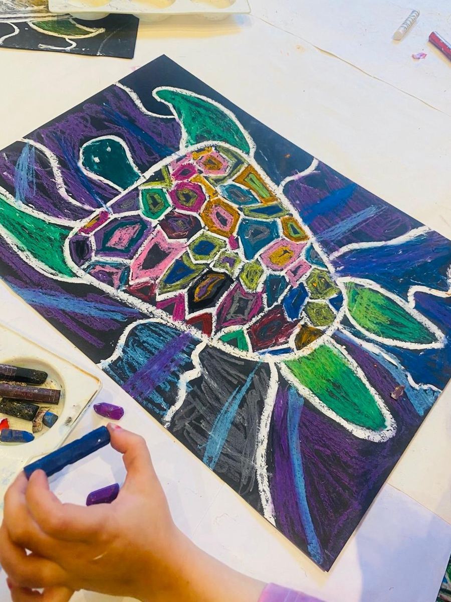 An oil pastel turtle with a patterned shell